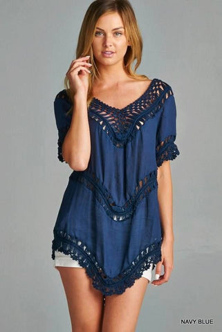 Solid, asymmetrical top featuring crochet detail and a draped, relaxed silhouette